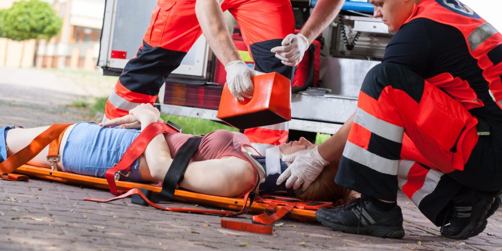 31804628 - paramedics giving first aid girl after accident